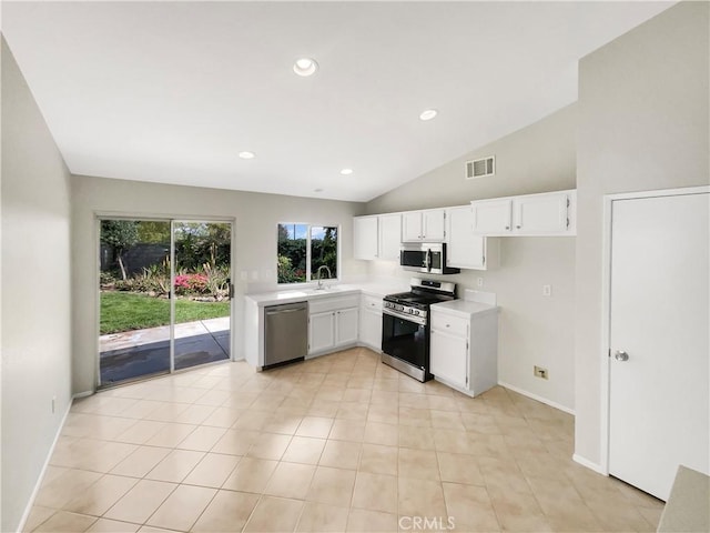 kitchen with light countertops, stainless steel appliances, white cabinets, and visible vents