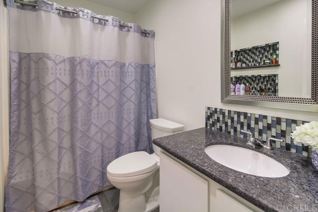 bathroom featuring vanity, a shower with curtain, and toilet