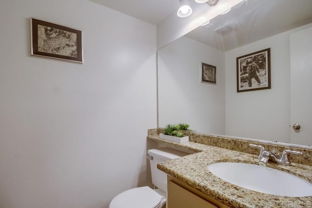 half bath with vanity and toilet