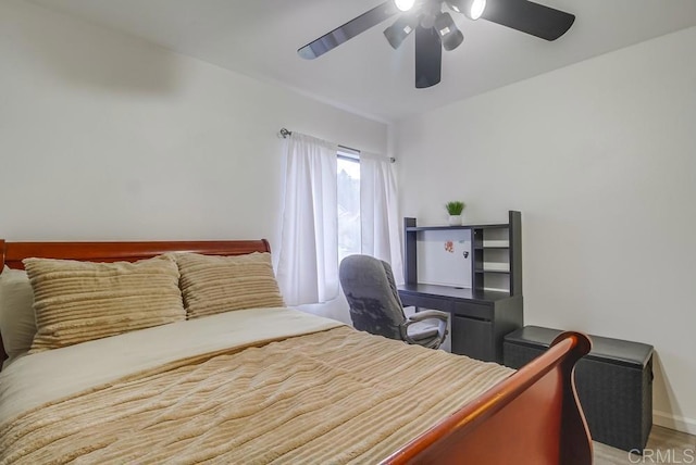 bedroom with a ceiling fan and baseboards