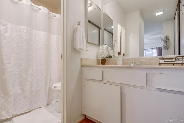 bathroom with toilet, tile patterned flooring, and vanity