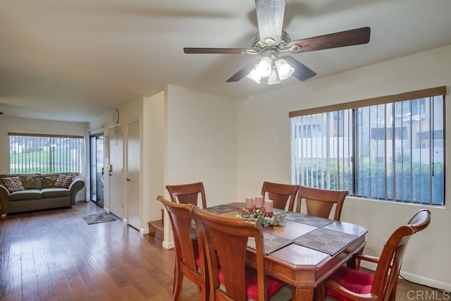 dining room featuring baseboards, ceiling fan, and wood finished floors