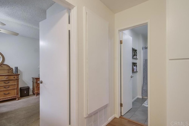hallway featuring a textured ceiling