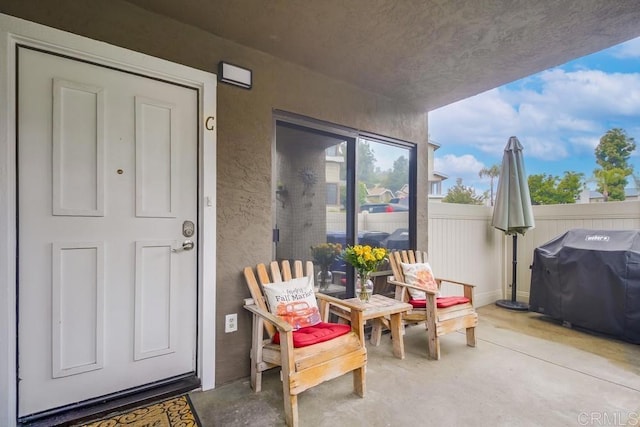 exterior space featuring fence, a patio area, and stucco siding