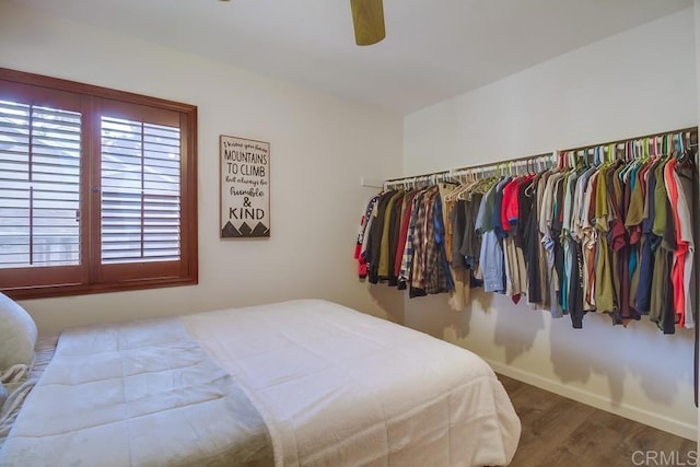 bedroom featuring a ceiling fan, baseboards, and wood finished floors