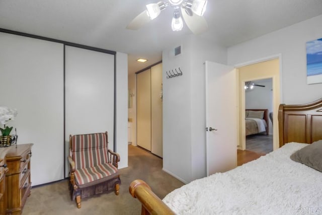 bedroom featuring carpet floors, ceiling fan, and visible vents