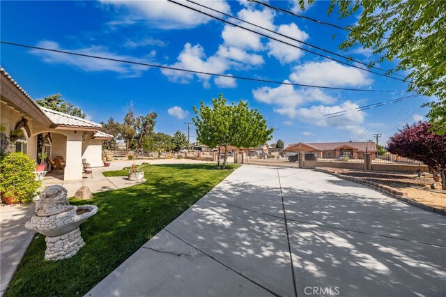 view of yard featuring fence and a patio area