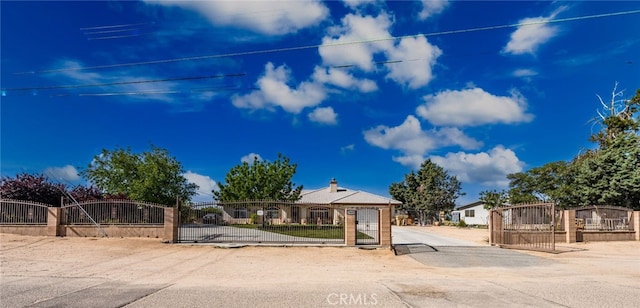 view of front of house featuring a fenced front yard and a gate