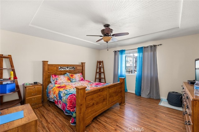 bedroom featuring baseboards, ceiling fan, and wood finished floors