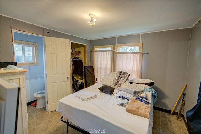 bedroom with tile patterned floors, a spacious closet, and a closet