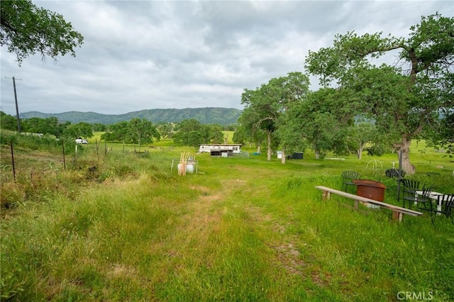 view of yard with a mountain view and a rural view
