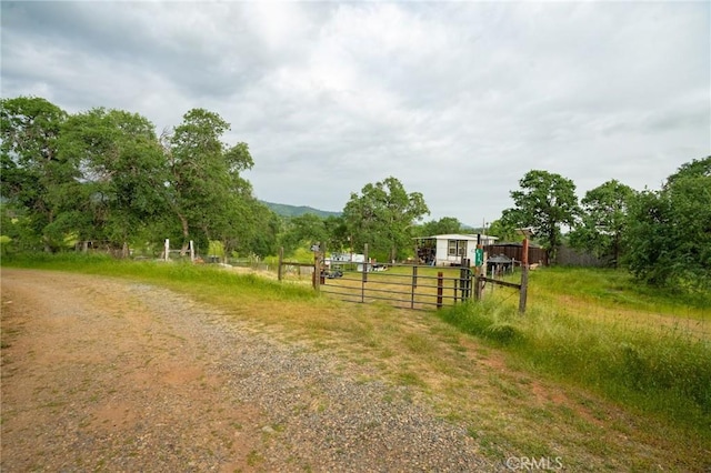 view of yard featuring a rural view and fence