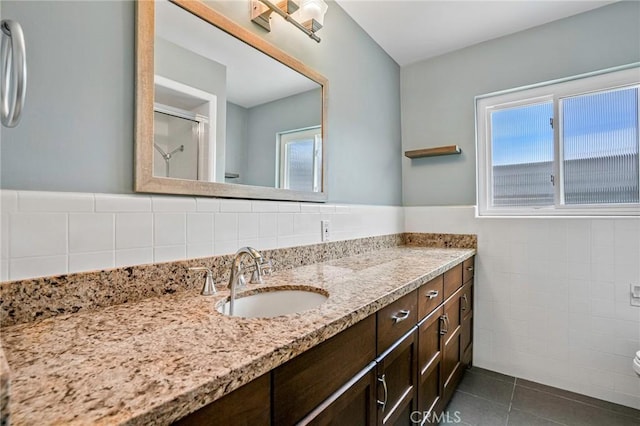 1130 E 1st St Unit 205, Long Beach, CA 90802 - bathroom with a shower with shower door, vanity, toilet, tile patterned floors, and tile walls