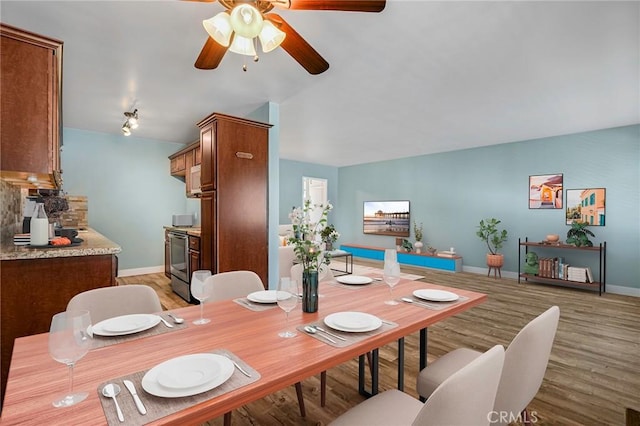 1130 E 1st St Unit 205, Long Beach, CA 90802 - dining space with baseboards, ceiling fan, and light wood finished floors