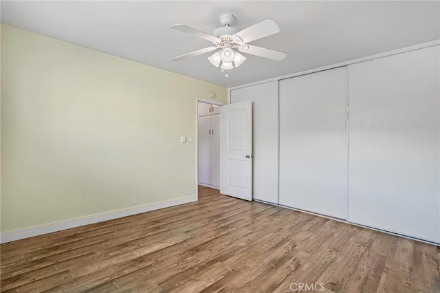1130 E 1st St Unit 205, Long Beach, CA 90802 - unfurnished bedroom with a closet, a ceiling fan, baseboards, and wood finished floors