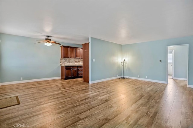 1130 E 1st St Unit 205, Long Beach, CA 90802 - unfurnished living room with baseboards, light wood-style flooring, and ceiling fan