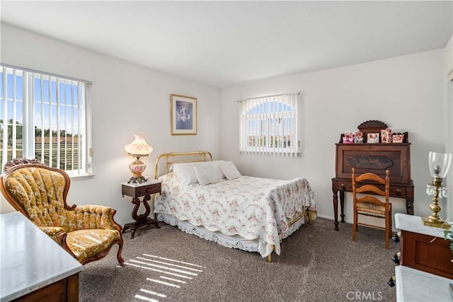 carpeted bedroom with baseboards and multiple windows