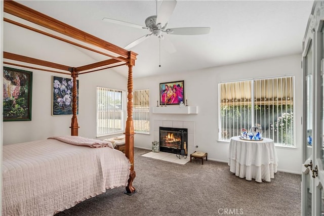 bedroom featuring vaulted ceiling with beams, a fireplace, carpet flooring, and ceiling fan