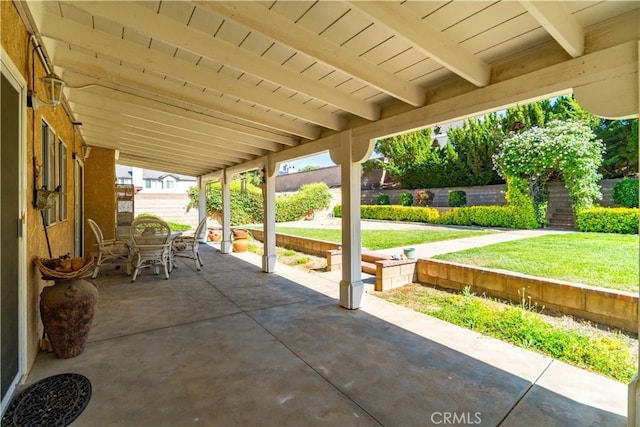 view of patio with outdoor dining area and a fenced backyard