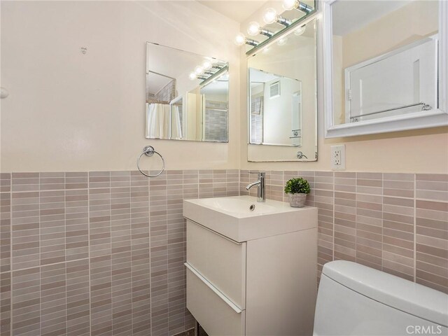 1234 N Pass Ave, Burbank, CA 91505 - bathroom with tile walls, vanity, toilet, and visible vents