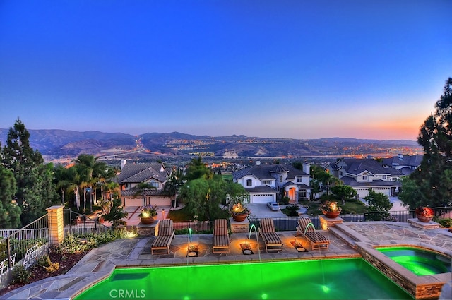26930 Ironstone, Yorba Linda, CA 92887 - pool at dusk with an in-ground hot tub, a mountain view, fence, and a residential view