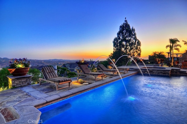 26930 Ironstone, Yorba Linda, CA 92887 - pool at dusk featuring a patio area and a pool with connected hot tub