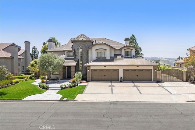 26930 Ironstone, Yorba Linda, CA 92887 - french provincial home with a chimney, concrete driveway, a gate, stucco siding, and a front yard