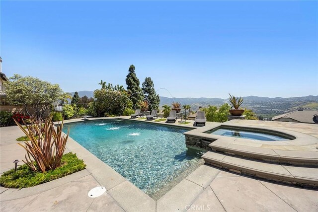 26930 Ironstone, Yorba Linda, CA 92887 - view of swimming pool with a mountain view, a patio, and a pool with connected hot tub