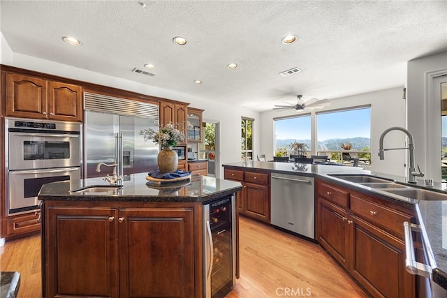 26930 Ironstone, Yorba Linda, CA 92887 - kitchen featuring beverage cooler, stainless steel appliances, a sink, recessed lighting, and plenty of natural light