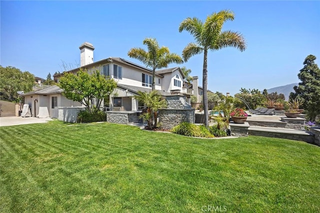26930 Ironstone, Yorba Linda, CA 92887 - back of property featuring a chimney, a yard, and stucco siding