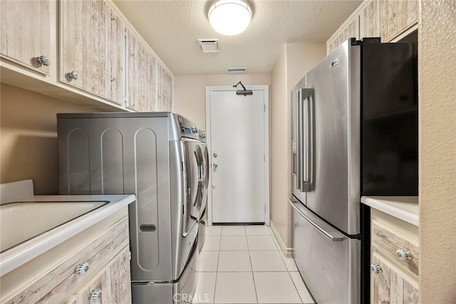 26930 Ironstone, Yorba Linda, CA 92887 - washroom with a textured ceiling, light tile patterned floors, and washer / clothes dryer