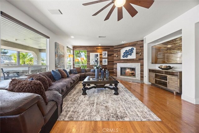 26930 Ironstone, Yorba Linda, CA 92887 - living room with ceiling fan, a large fireplace, wood finished floors, wooden walls, and recessed lighting
