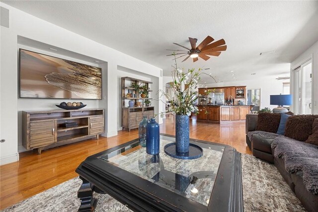 26930 Ironstone, Yorba Linda, CA 92887 - living area featuring a ceiling fan, light wood-type flooring, and a textured ceiling