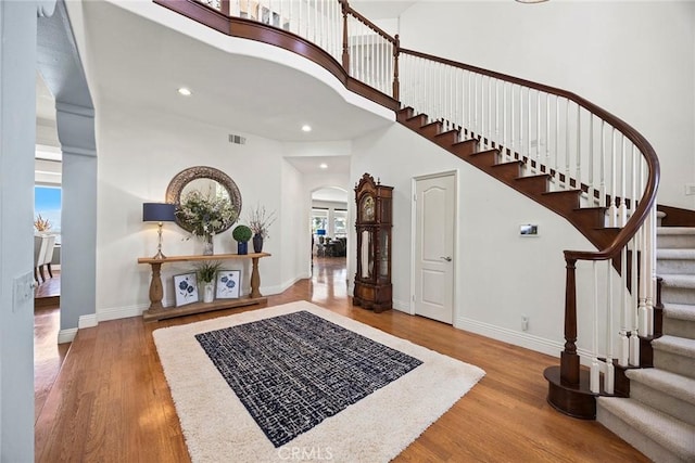 26930 Ironstone, Yorba Linda, CA 92887 - foyer with wood finished floors, arched walkways, stairway, a high ceiling, and baseboards