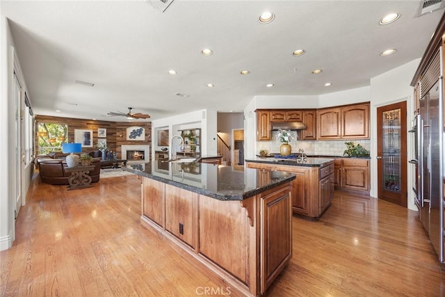 26930 Ironstone, Yorba Linda, CA 92887 - kitchen featuring a center island with sink, a sink, recessed lighting, brown cabinets, and light wood-style floors