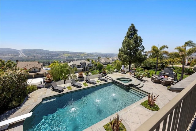 26930 Ironstone, Yorba Linda, CA 92887 - view of swimming pool with a lit fireplace, a patio area, a mountain view, a pool with connected hot tub, and a residential view