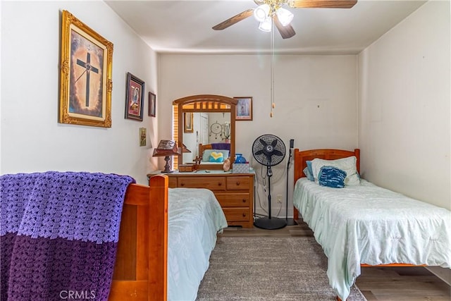 bedroom with a ceiling fan and wood finished floors