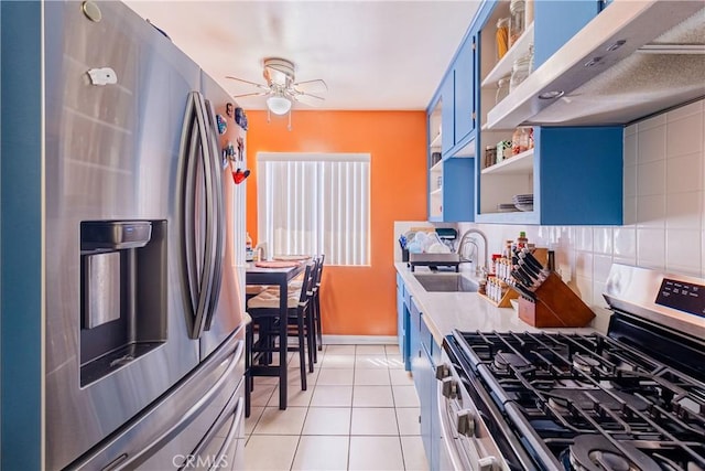 kitchen with blue cabinets, open shelves, a sink, under cabinet range hood, and stainless steel appliances