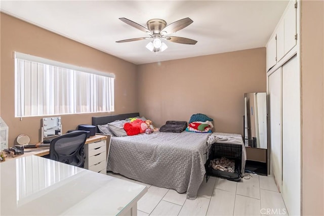 bedroom featuring ceiling fan and a closet