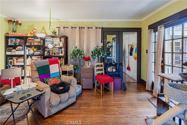 living room with crown molding and wood finished floors
