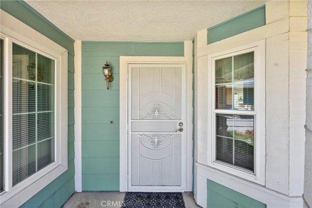 view of exterior entry with a porch