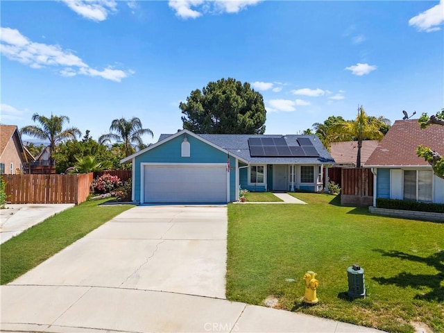 view of front of house featuring solar panels, an attached garage, and driveway