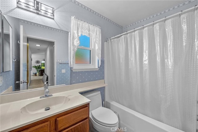 full bathroom featuring wallpapered walls, toilet, shower / tub combo, and vanity