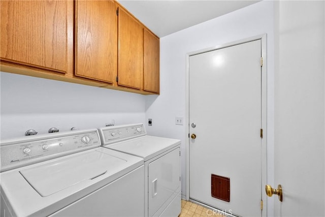 washroom featuring cabinet space and independent washer and dryer