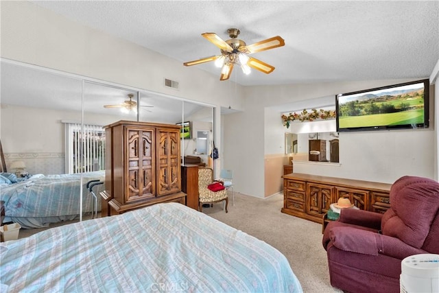 carpeted bedroom with a textured ceiling and a ceiling fan