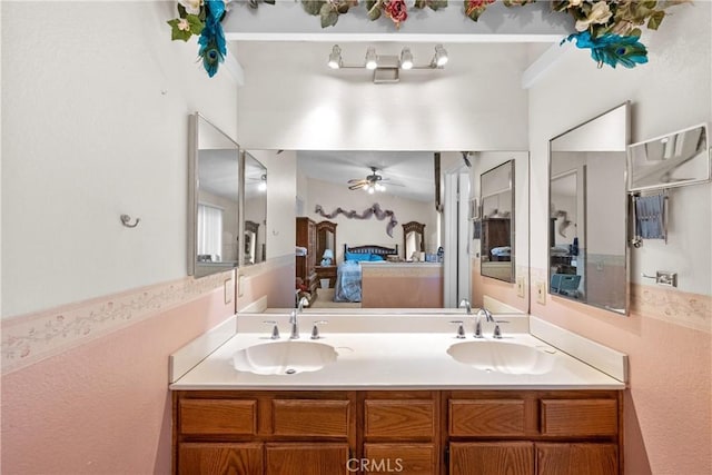 bathroom with ensuite bath, ceiling fan, and double vanity