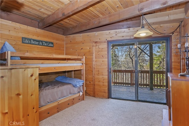 carpeted bedroom featuring wooden walls, access to outside, beam ceiling, and wood ceiling