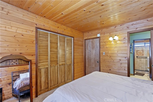 bedroom with wooden walls, wood ceiling, ensuite bathroom, and carpet floors