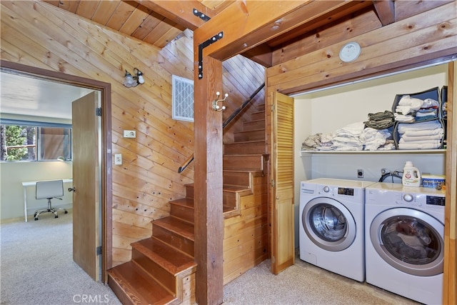 washroom with laundry area, wooden walls, and light carpet