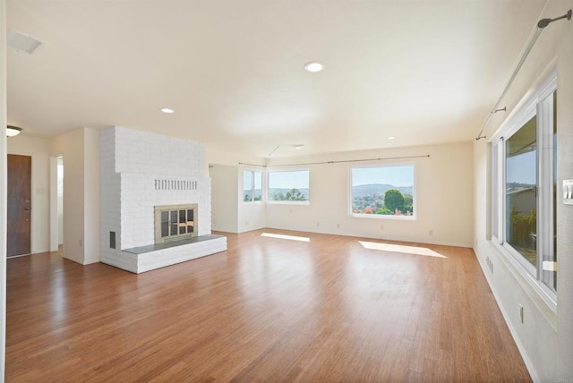5884 Redondo Dr, Bonsall, CA 92003 - unfurnished living room with wood finished floors, a fireplace, recessed lighting, and baseboards
